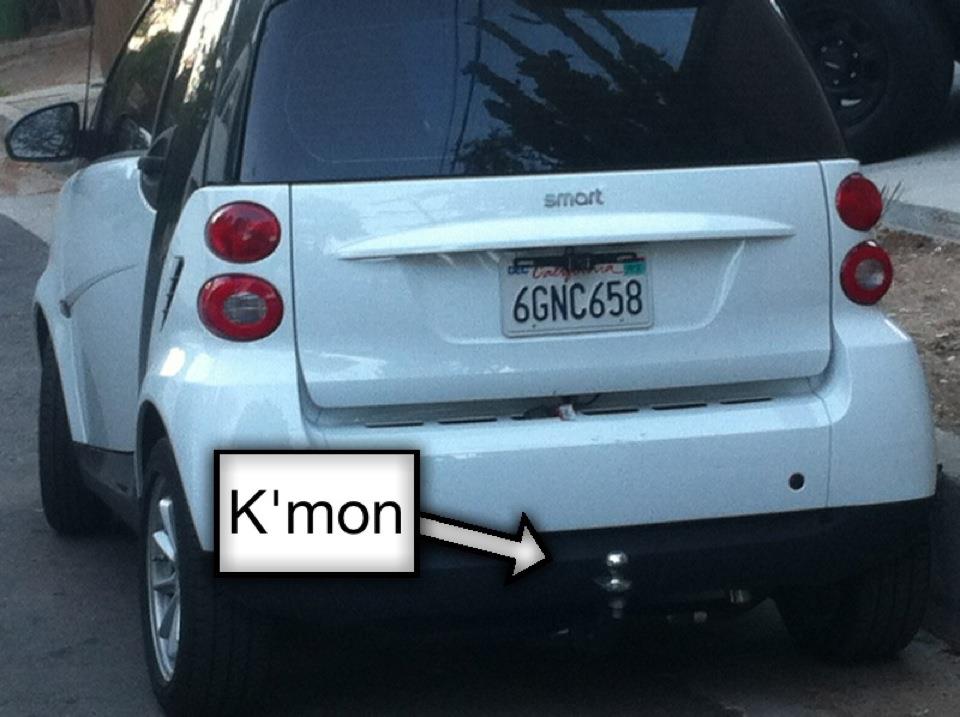 White Smart car rear with hitch and California license plate 6GNC658