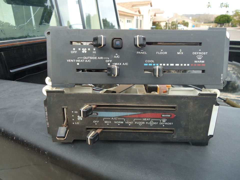 Climate control panel with knobs and sliders for fan speed, temperature, and air direction
