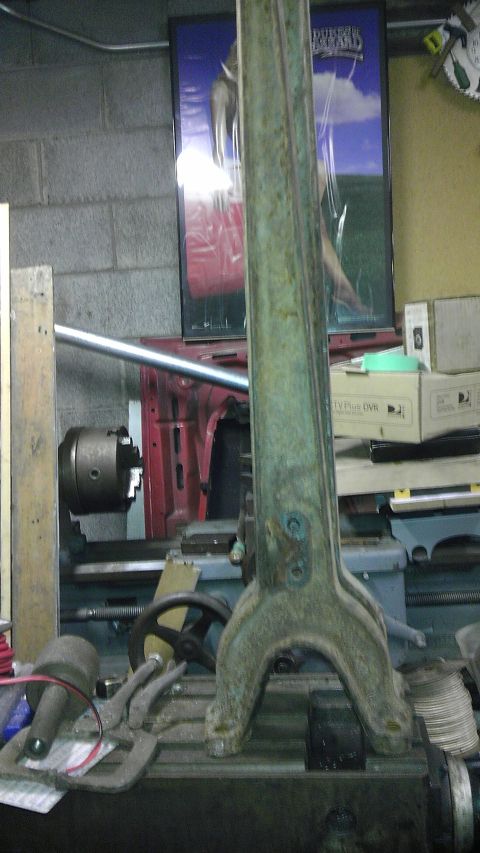 1987 Ford Ranger - A large, weathered metal component rests on a workbench, obscuring a poster and part of a lathe.
