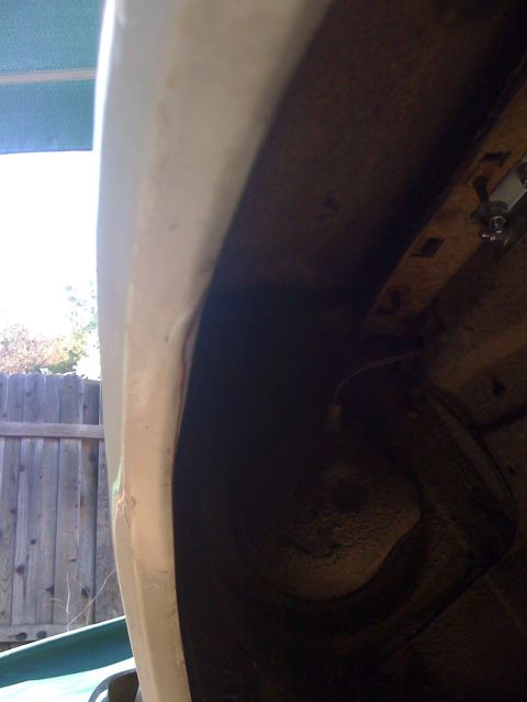 1964 Ford Ranchero - Interior view of a vehicle's wheel well, revealing rust and exposed wiring.