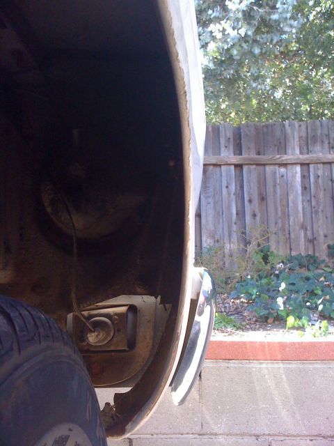 1964 Ford Ranchero - Detail shot of the rear fender well and bumper assembly, showing signs of wear and tear.