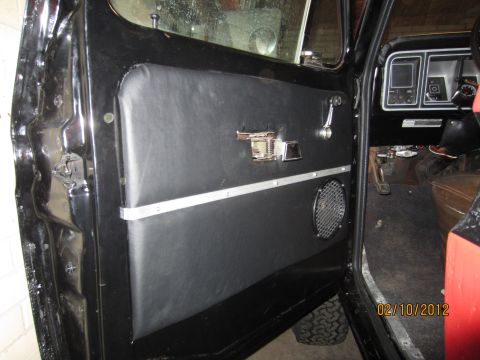 1979 Ford Bronco - Interior view of a 1979 Ford Bronco showing the driver's side door panel and part of the dashboard.