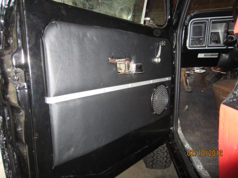 1979 Ford Bronco - The interior of a vehicle is shown, focusing on the door panel and dashboard details.