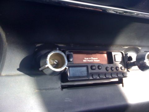 1964 Ford Ranchero - Close-up of a car's dashboard showing a stereo unit and a cigarette lighter socket.