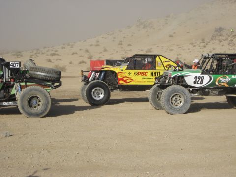 1996 Ford Bronco - Multiple off-road vehicles compete in a desert race event.