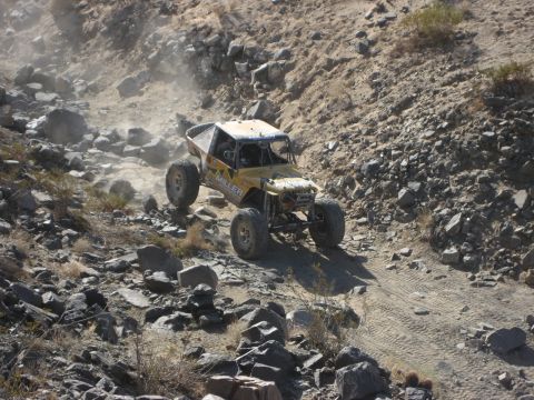 1996 Ford Bronco - An off-road buggy navigates a challenging rocky terrain during an event.