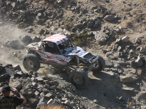 1996 Ford Bronco - Custom off-road buggy navigates a challenging rocky trail during an event.