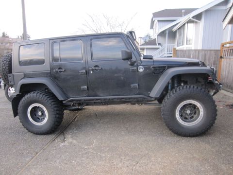 2008 Jeep Wrangler - This Jeep Wrangler features a side-mounted spare tire and aggressive off-road tires.