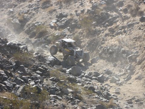 1996 Ford Bronco - This custom off-road buggy tackles a challenging rocky terrain, demonstrating its extreme capability.