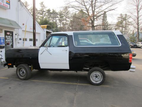 1987 Dodge 1500 - This two-tone pickup truck with a camper shell appears to be from the 1980s, not a 1987 model.