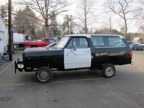 1987 Dodge 1500 - This two-tone SUV, likely a 1987 Dodge Ramcharger, is seen from the side.