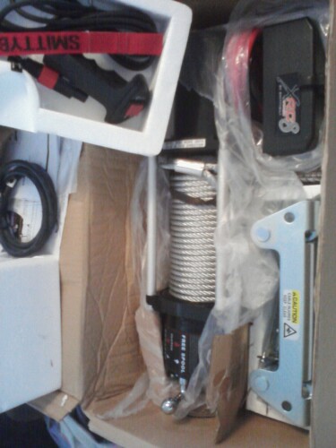 1989 Ford Bronco - A new winch is shown packed in its box with protective foam and plastic.