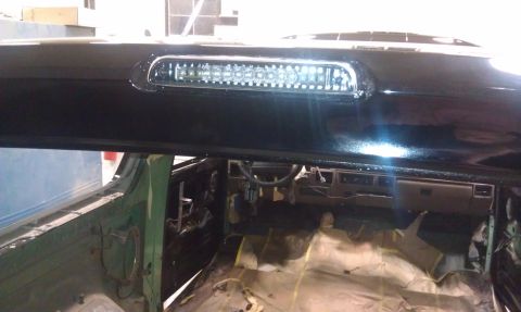 1995 Ford Bronco - The interior of a 1992 Ford Bronco shows its dashboard and exposed flooring, with a black third brake light mounted above.