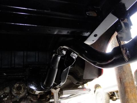 1995 Ford Bronco - Undercarriage view shows the rear suspension and exhaust system of a vehicle.