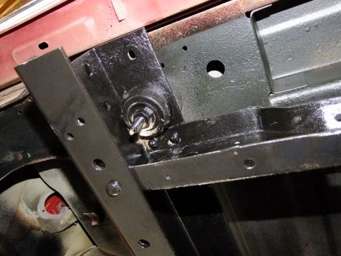 1995 Ford Bronco - Detail of a vehicle's undercarriage, showing a newly painted chassis component and hardware.