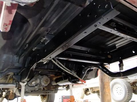 1995 Ford Bronco - The underbody of a 1995 Ford Bronco shows a clean chassis and drivetrain following detailing.