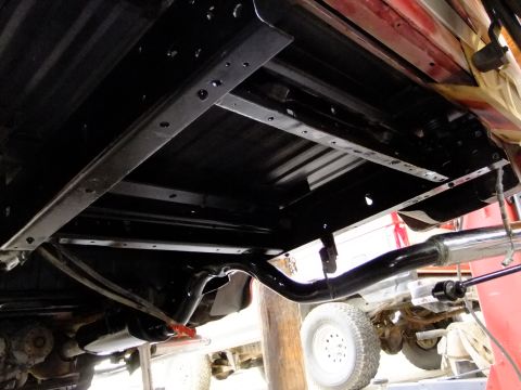 1995 Ford Bronco - The underbody of a 1995 Ford Bronco shows the frame, exhaust, and rear axle after detailing.