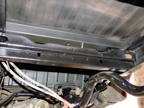 1995 Ford Bronco - The underside of a vehicle's chassis, showing the exhaust system and suspension components.