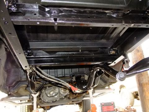 1995 Ford Bronco - The underside of a 1995 Ford Bronco shows a freshly detailed chassis with a clean drivetrain and suspension components.