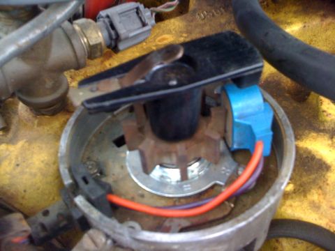 1964 Ford Ranchero - This image shows the internal components of a vehicle's ignition system, specifically the distributor cap and rotor.