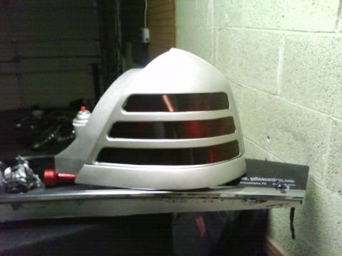 1999 Ford Crown Victoria - Aftermarket taillight assembly for a car, possibly a Ford Crown Victoria, shown in a workshop.