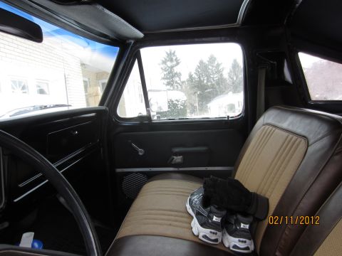 1979 Ford Bronco - The interior of a 1979 Ford Bronco shows its two-tone seats and a glimpse of the snowy exterior through the windows.