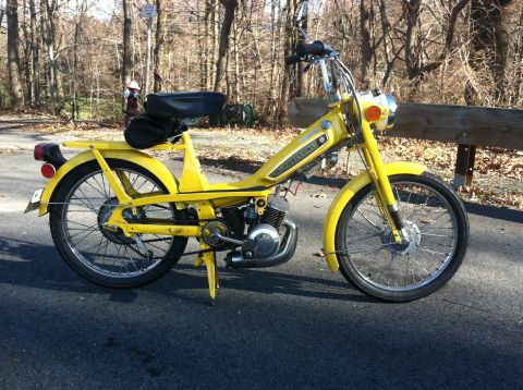 1981 Garelli Rally Sport - A yellow moped with the name 'Motobecane' visible on its side is parked outdoors on a paved surface.