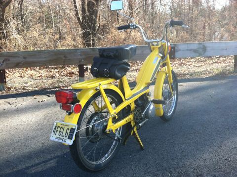 1981 Garelli Rally Sport - A yellow moped is parked on the side of the road, showing its rear end and license plate.