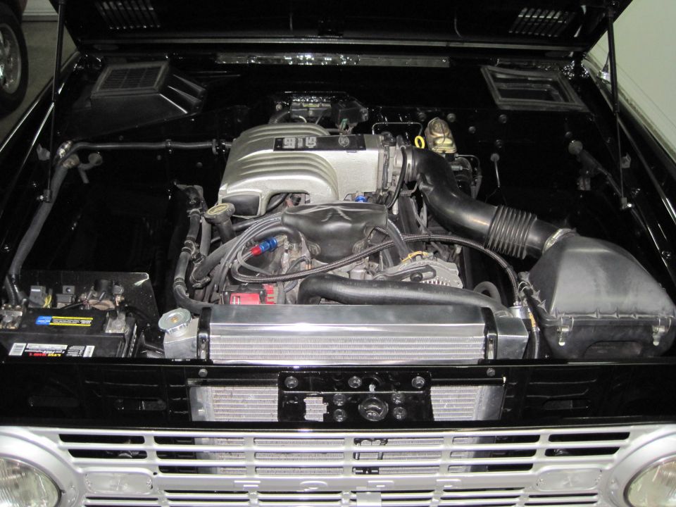 Ford Bronco engine bay with 5.0 EFI V8 swap and polished coolant tank