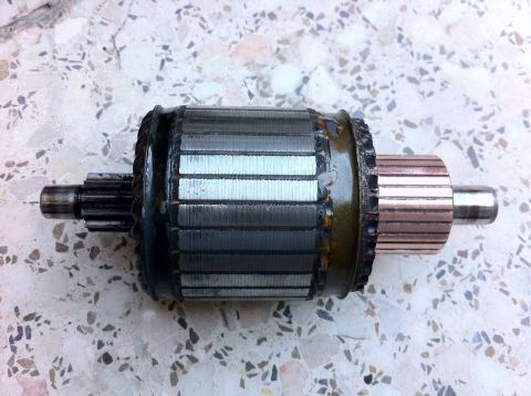 1998 Ford Crown Victoria - A disassembled starter motor armature is shown, highlighting its internal components and construction.