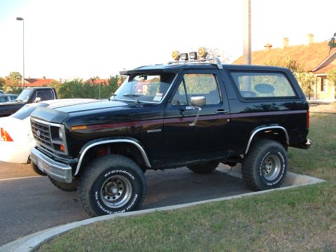 1985 Ford Bronco - This black 1985 Ford Bronco features off-road tires and auxiliary lights mounted on the roof rack.
