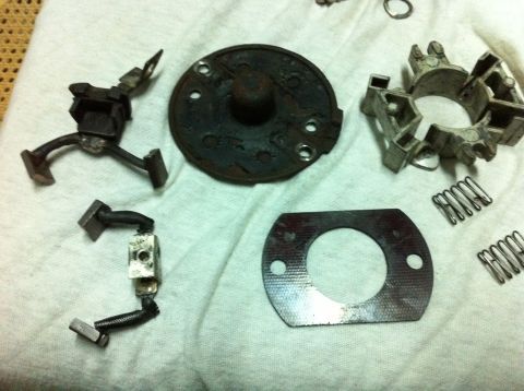 1998 Ford Crown Victoria - Various parts of a disassembled starter motor are laid out on a white cloth.