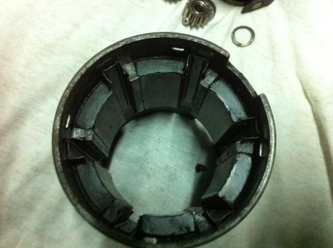 1998 Ford Crown Victoria - A disassembled starter motor component is shown, revealing its internal structure and metal casing.