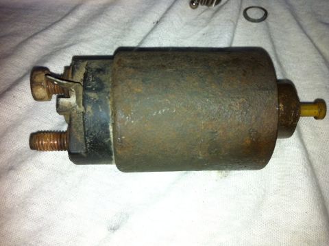 1998 Ford Crown Victoria - Starter motor, likely for an older vehicle, shown on a white cloth surface.