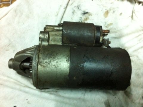 1998 Ford Crown Victoria - A car starter motor is shown resting on a white cloth, with a Supermotors.net watermark in the corner.
