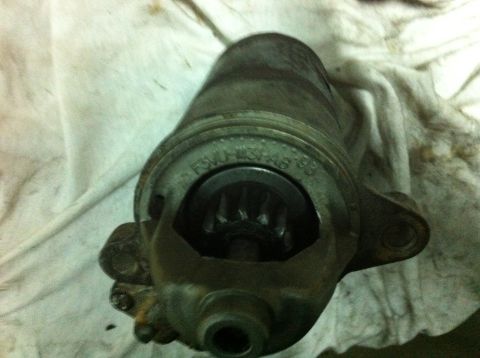 1998 Ford Crown Victoria - A starter motor, possibly from a 1998 vehicle, is shown with its gear mechanism exposed.