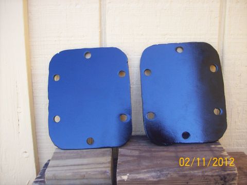 1982 Ford F-100 - Two blue metal plates, possibly for a vehicle's drivetrain, are shown against a wooden background. The date 02/11/2012 is visible.