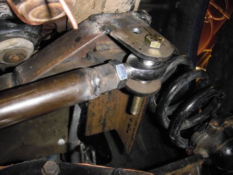 1995 Ford Bronco - This image shows a close-up view of a vehicle's suspension system, focusing on a joint and coil spring.