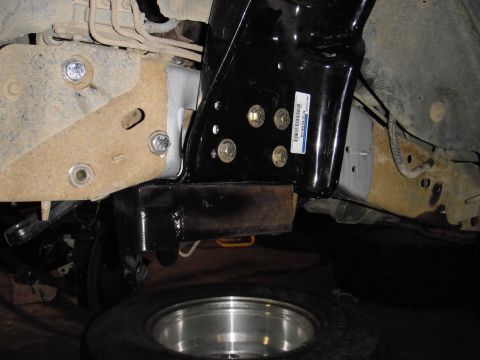 1995 Ford Bronco - Underside view of vehicle frame components, including suspension and a spare tire.