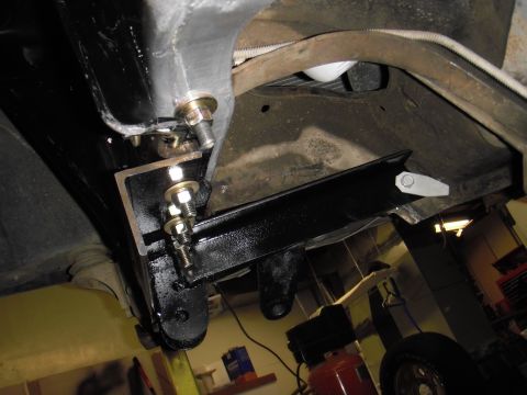 1995 Ford Bronco - Close-up view of the undercarriage, revealing newly installed aftermarket components attached to the vehicle's frame.