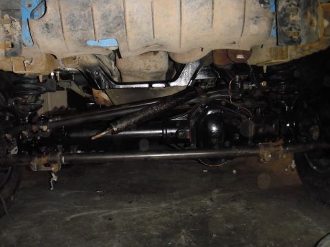 1995 Ford Bronco - A close-up view of the undercarriage reveals the suspension and drivetrain components of a vehicle.