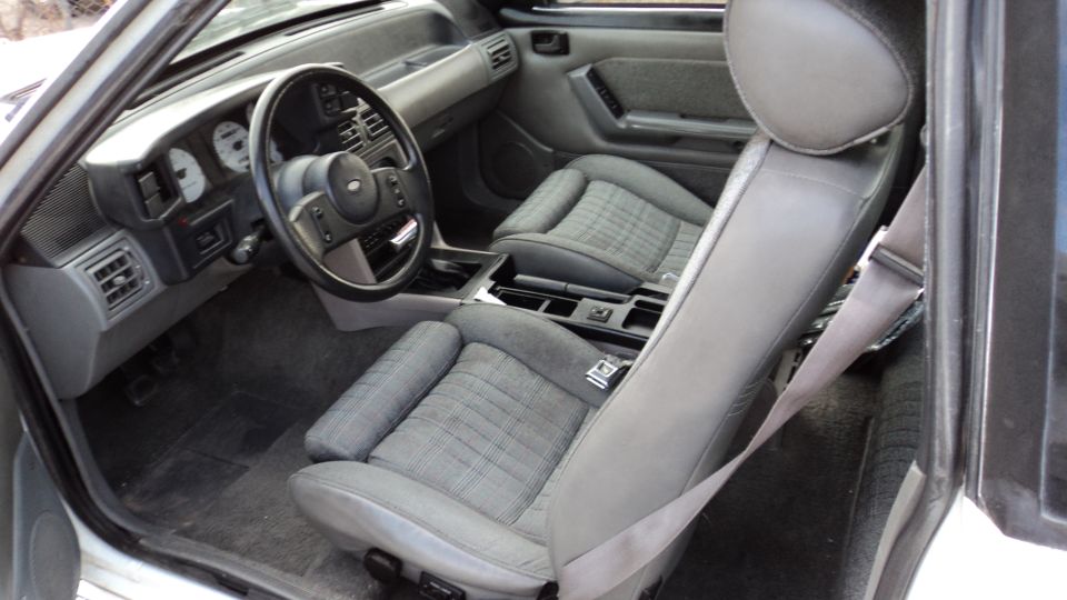 1989 Ford Mustang interior with grey cloth seats and dashboard
