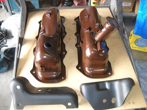 1992 Ford Explorer - Engine valve covers and mounting brackets laid out on a workbench.