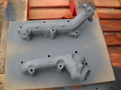 1992 Ford Explorer - Two exhaust manifolds, possibly for a Ford vehicle, are shown after being painted.