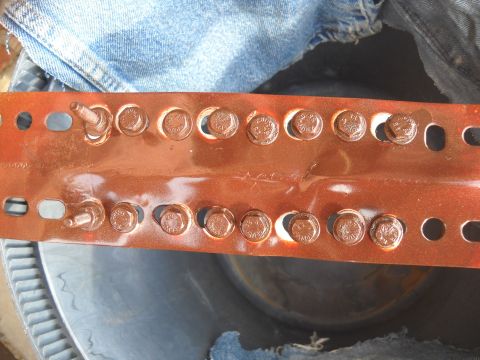 1992 Ford Explorer - A metal bracket with multiple bolts is shown, partially obscured by denim fabric.