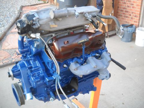 1992 Ford Explorer - Engine on stand with visible oil cap and exhaust manifold.