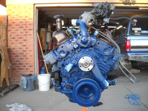 1992 Ford Explorer - A freshly painted blue engine is mounted on a stand, ready for installation.