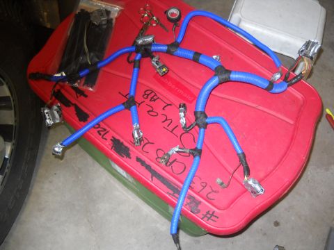 1992 Ford Explorer - A blue wiring harness with various connectors is laid out on a red plastic storage bin, with some handwritten labels visible.