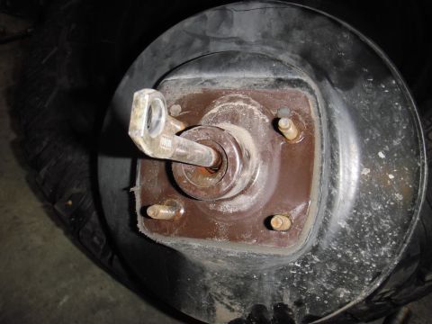 1995 Ford Bronco - This image shows a close-up view of a vehicle's brake drum assembly, including the lug nut and studs.