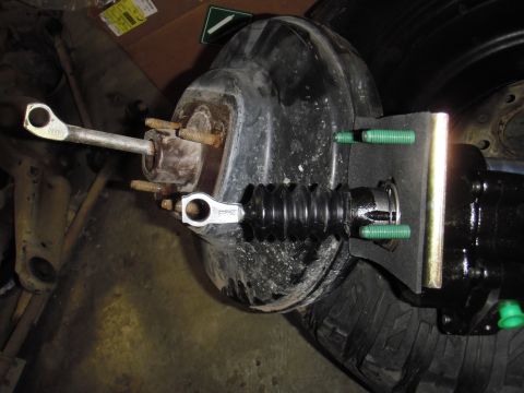 1995 Ford Bronco - Close-up of a brake booster and master cylinder assembly, showing mechanical components.